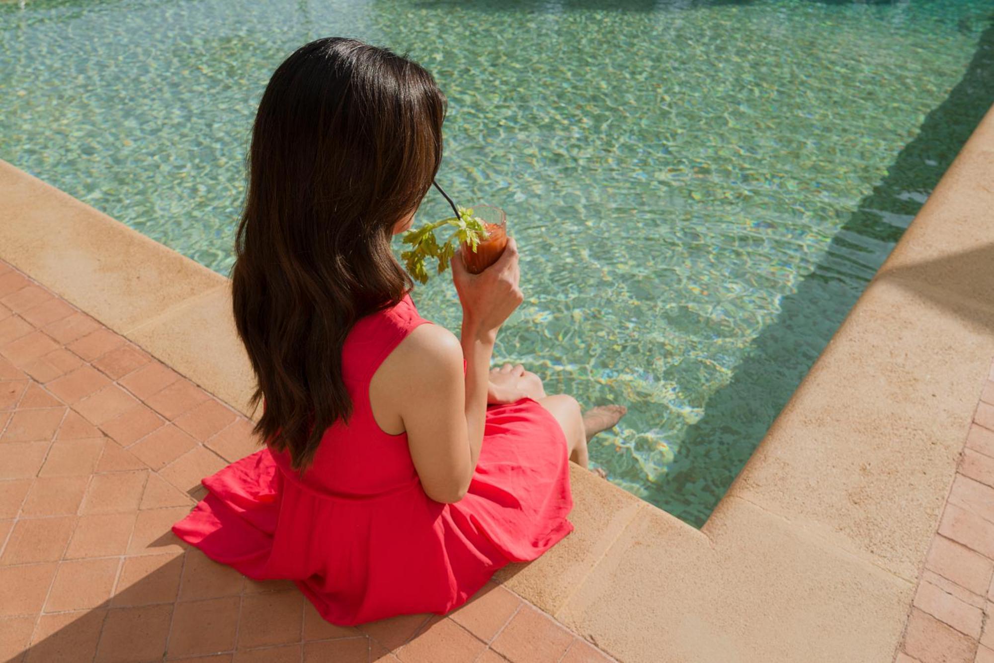 Villa Athena Resort Agrigento Kültér fotó A woman sitting by a pool